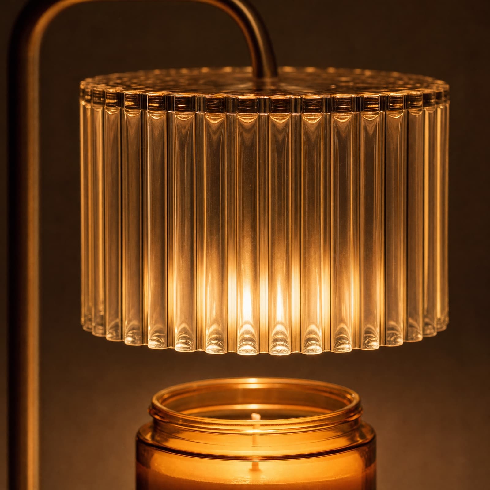 Close on the ribbed glass drum, each rod catching its own streak of warm light, with the jar mouth just below it.